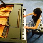 young student playing piano