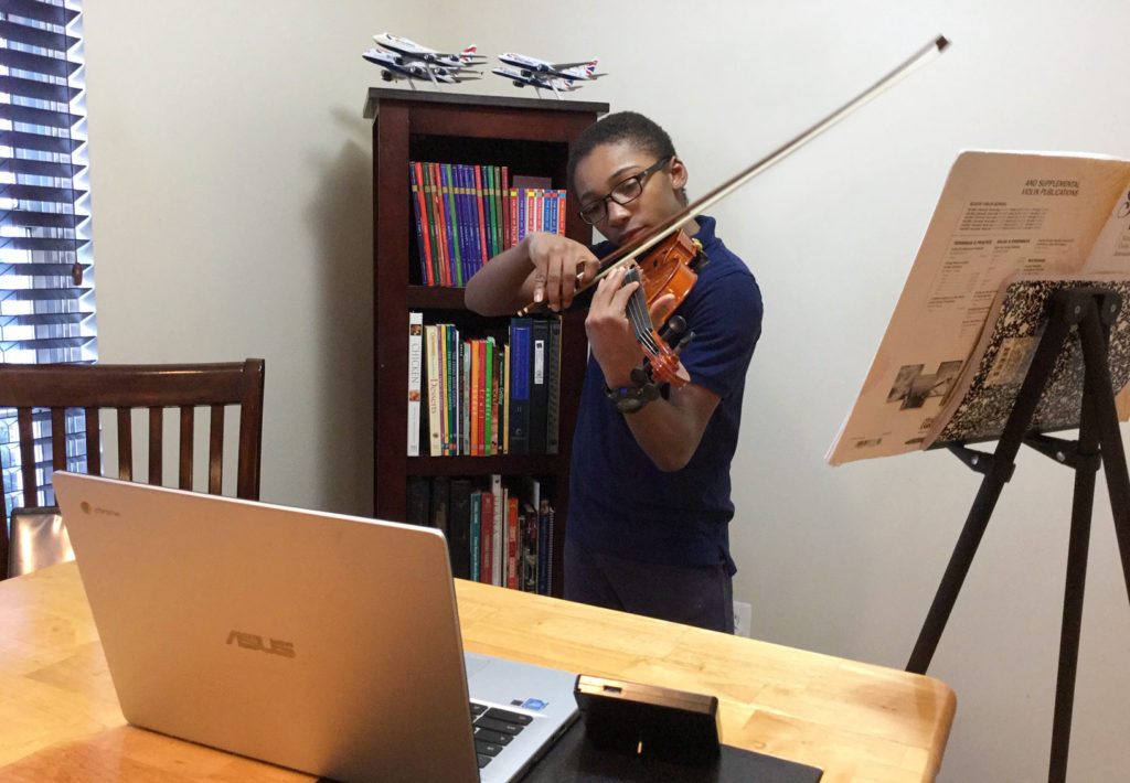 Student taking a remote violin lesson