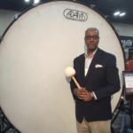 Greg Holloway standing in front of an extra large bass drum